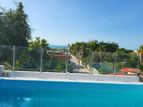 a view of a swimming pool with a fence at Hostal Casa Familiar Josi in Tolú