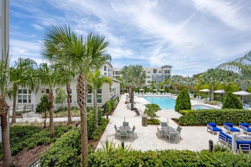a view of the pool at the resort at Gated Resort Style 2BR - KING Bed, Pool Views, SPA Hot Tub, Gym, WiFi, Wash & Dry, AC, Elevators, Starbucks, EV CHRG Station, Free Parking, Pets -- IDEAL FOR Medical, Business, Relocation, Long Stays - by Moffitt Cancer Ctr, USF, River Hills Country Club in Tampa