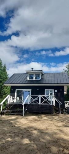a black house with a window on top of it at Kieloranta in Kuopio