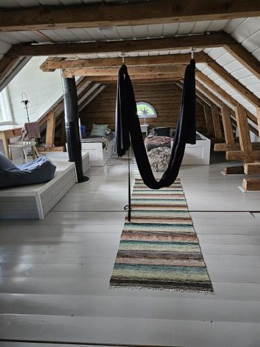a living room with a hammock in a room at Kieloranta in Kuopio