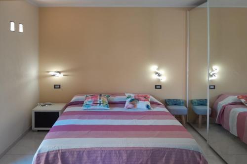 a bedroom with a large bed and a mirror at La Casina in Laglio