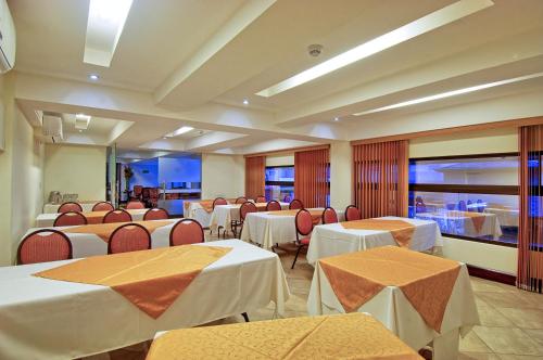 a banquet hall with tables and chairs with white table cloth at Balmoral Hotel San José CR, Historic District in San José