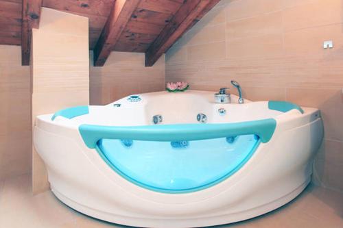 a large bath tub in a bathroom with a sink at Navigli Downtown Cocco House in Milan