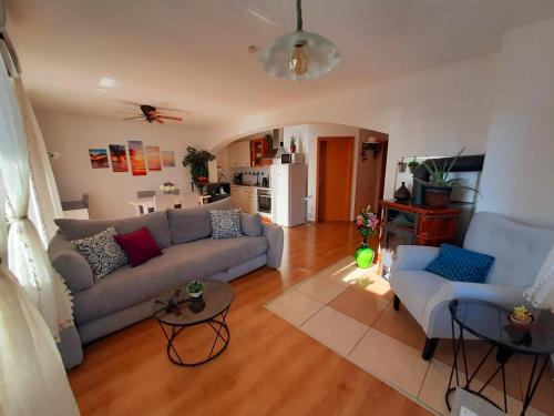 a living room with a couch and two chairs at Solis in Sveti Vid-Miholjice