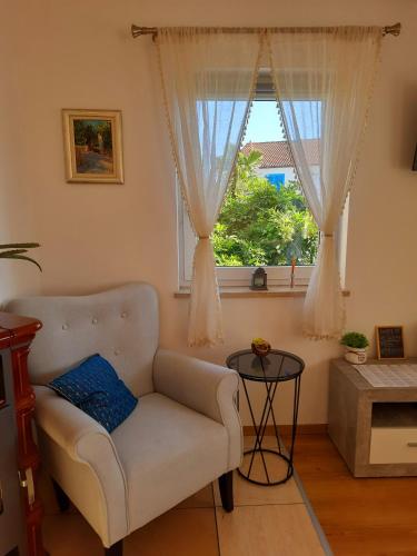 a living room with a couch and a window at Solis in Sveti Vid-Miholjice