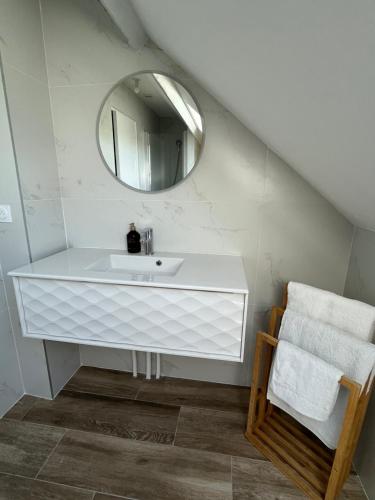 a bathroom with a white sink and a mirror at Family Disney coconing à 10 minutes du Parc in Coupvray