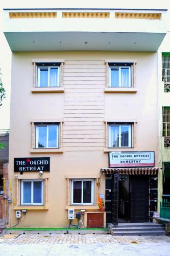 a large white building with a sign on it at The Orchid Retreat in Agra