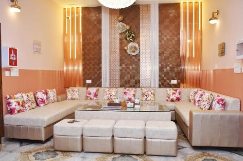 a living room with a couch and a table at The Orchid Retreat in Agra