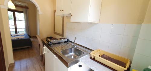 a kitchen with a sink and a counter top at Phivos Hotel in Paleokastritsa
