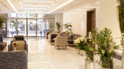 a waiting room with chairs and plants in a building at فندق مادن طيبة MADEN Taiba HOTEL in Al Madinah