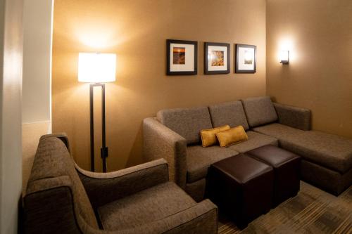 a living room with a couch and a chair at Comfort Suites University Brookings in Brookings