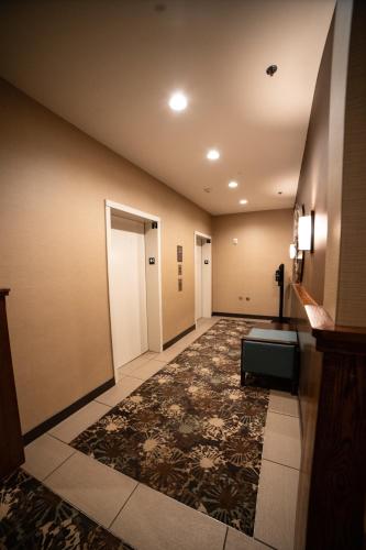 a hallway of a hotel room with a carpeted floor at Comfort Suites University Brookings in Brookings