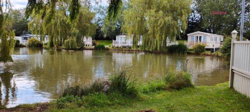 a body of water with houses and trees at Nikola in Skegness