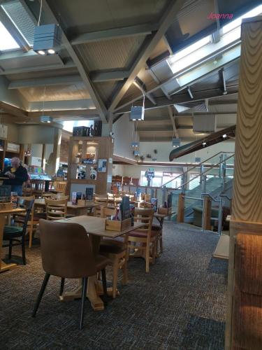 a dining room with wooden tables and chairs at Nikola in Skegness