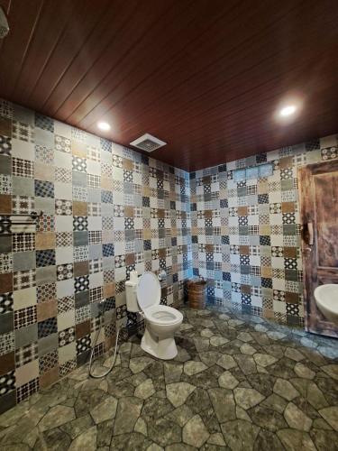 a bathroom with a toilet and a sink at Melasti Mountain Villas Amed in Amed
