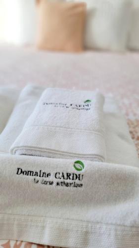 a pile of towels sitting on top of a bed at DOMAINE CARDU in Cardo-Torgia