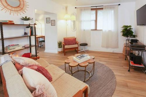 a living room with a couch and a table at Classic & Cozy Apartments - Parking & Close To Dw in Medford