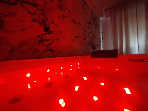 a red bath tub filled with lots of lights at Sparkling Suite in Dolceacqua