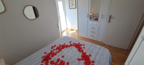a room with a table with red rose petals on it at Port PENTHOUSE in Tarragona
