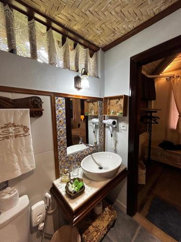 a bathroom with a sink and a toilet at Chalé Segredo da Serra in Tiradentes
