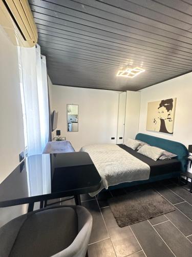 a bedroom with a bed and a desk and chairs at Apartmani Vernissage in Biograd na Moru