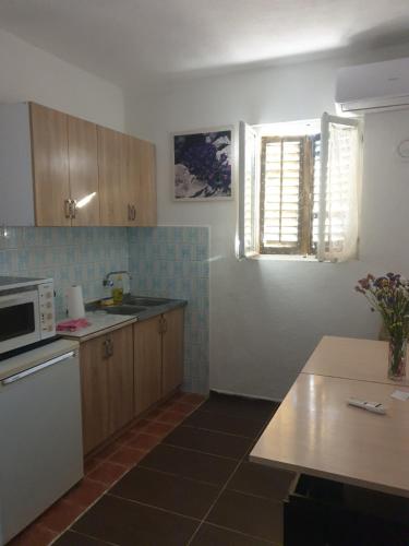 a kitchen with a sink and a microwave at Apartman Tomas in Trebinje