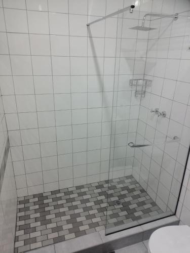 a bathroom with a shower with a glass door at Darize Self Catering Flat in Kimberley