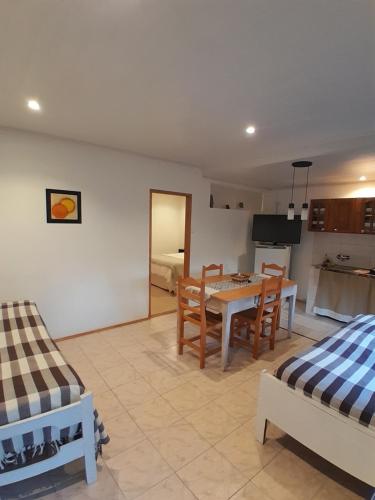 a kitchen and living room with a table and chairs at El Nogal in Coronel Suárez