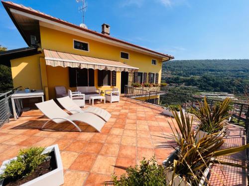 a patio with chairs and tables on a house at b&b Antiche Pietre in Bollengo