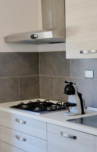 a kitchen with a stove top oven in a kitchen at Monnalisa Village in Fiumicino