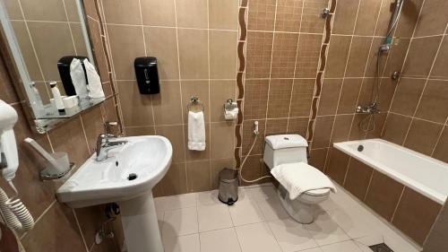 a bathroom with a sink and a toilet and a shower at Jazan Inn Hotel in Jazan