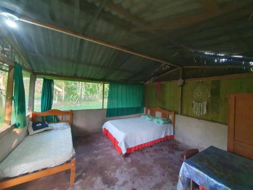 a bedroom with two beds in a tent at Centro de Medicina y Posada Indigenawa in Cruzeiro do Sul