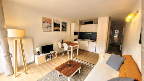 un salon avec un canapé et une table dans l'établissement Appartement au coeur du village de Saint-Lary-Soulan 2 personnes, à Saint-Lary-Soulan