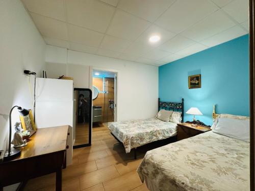 a hotel room with two beds and a mirror at Mirador 5 del Mercado Central - habitacion con baño privado en el centro de la Ciudad Vella in Valencia