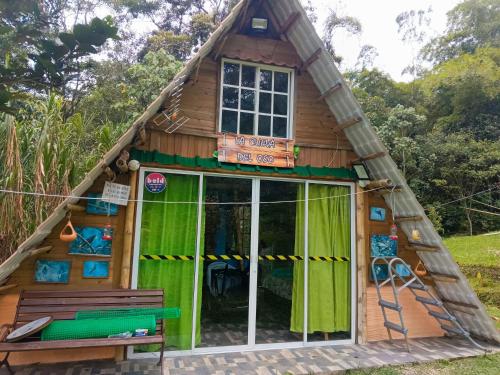 a small wooden house with a green door at Glamping eco descanso la vega Nocaima in Nocaima