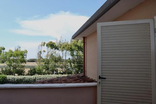 a door to a balcony with a view at Monnalisa Village in Fiumicino