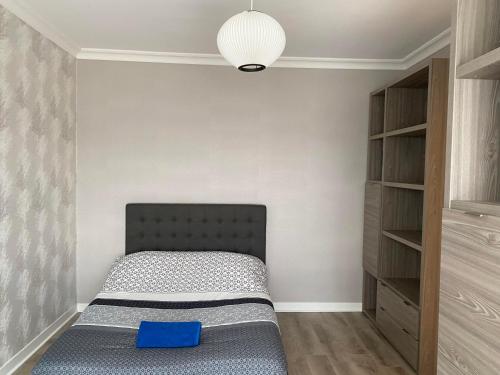 a bedroom with a bed with a blue pillow at Villa Les Tourelles in Flers
