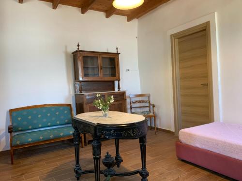 a room with a table and a bedroom with a bed at Artemis in Agia Marina
