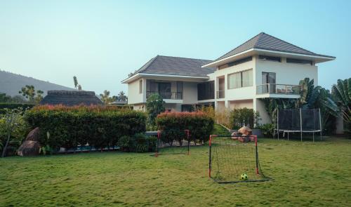 a house with a yard with a goal at ORO The Estates, Nandi Hills in Nandigunda
