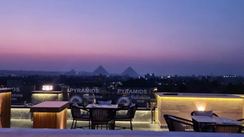 a view of the pyramids from the roof of a restaurant at Pyramids Sunshine View in Cairo