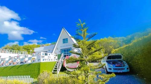 a house with a car parked in front of it at The I-style pool villa in Ban Tao Than