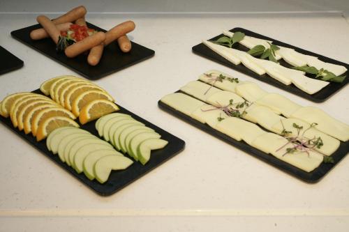 four plates of cheese and vegetables on a table at Kilim Boutique Hotel in Baku
