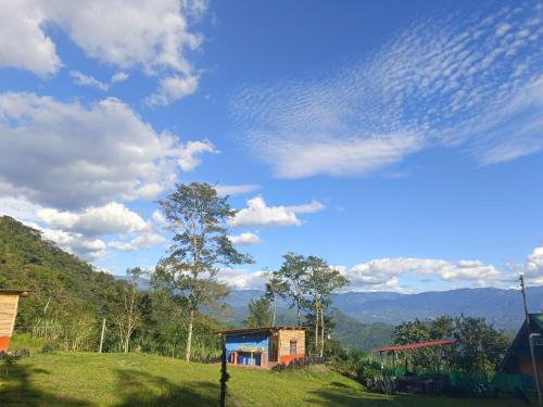 a small house on a hill with a cloudy sky at Glamping eco descanso la vega Nocaima in Nocaima