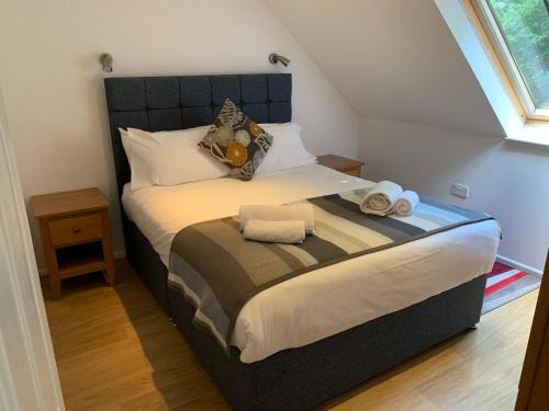 ein Schlafzimmer mit einem großen Bett, auf dem Handtücher liegen in der Unterkunft Selwood Cottage in Beckington