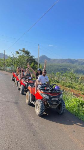 a group of people riding on atvs down a road at CHALET TROPICAL Hotel & Restaurant-Pizzeria in Las Galeras