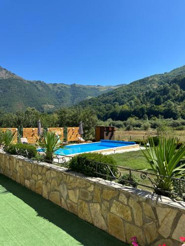 a view of a swimming pool with mountains in the background at Vila Kristina in Andrijevica
