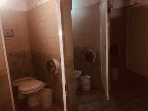 a bathroom with a toilet and a shower stall at Hotel Chipre in Buenos Aires