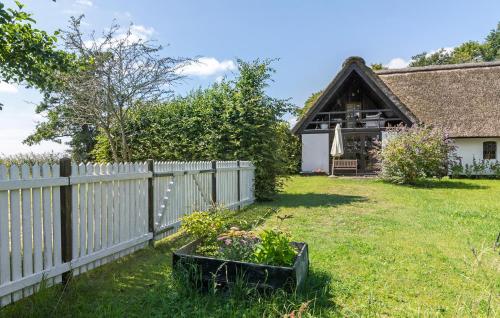 a garden with a fence and a house at Nice Apartment In Rønde With Wifi in Rønde
