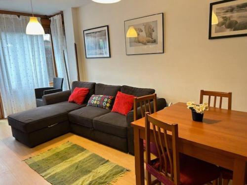 a living room with a couch and a table at Apartamento Playa de Barro in Barro de Llanes