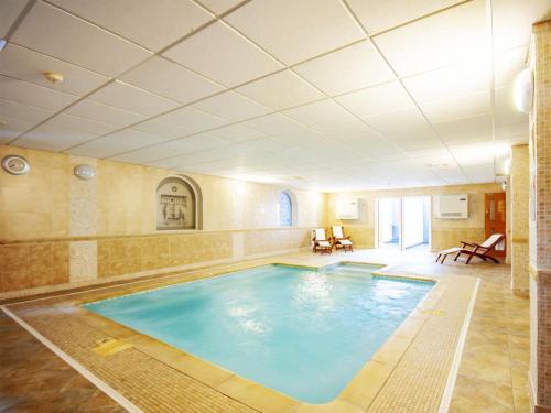 a large swimming pool in a large room at White Waters Hotel in Llangollen